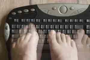 Stock image of person typing with toes