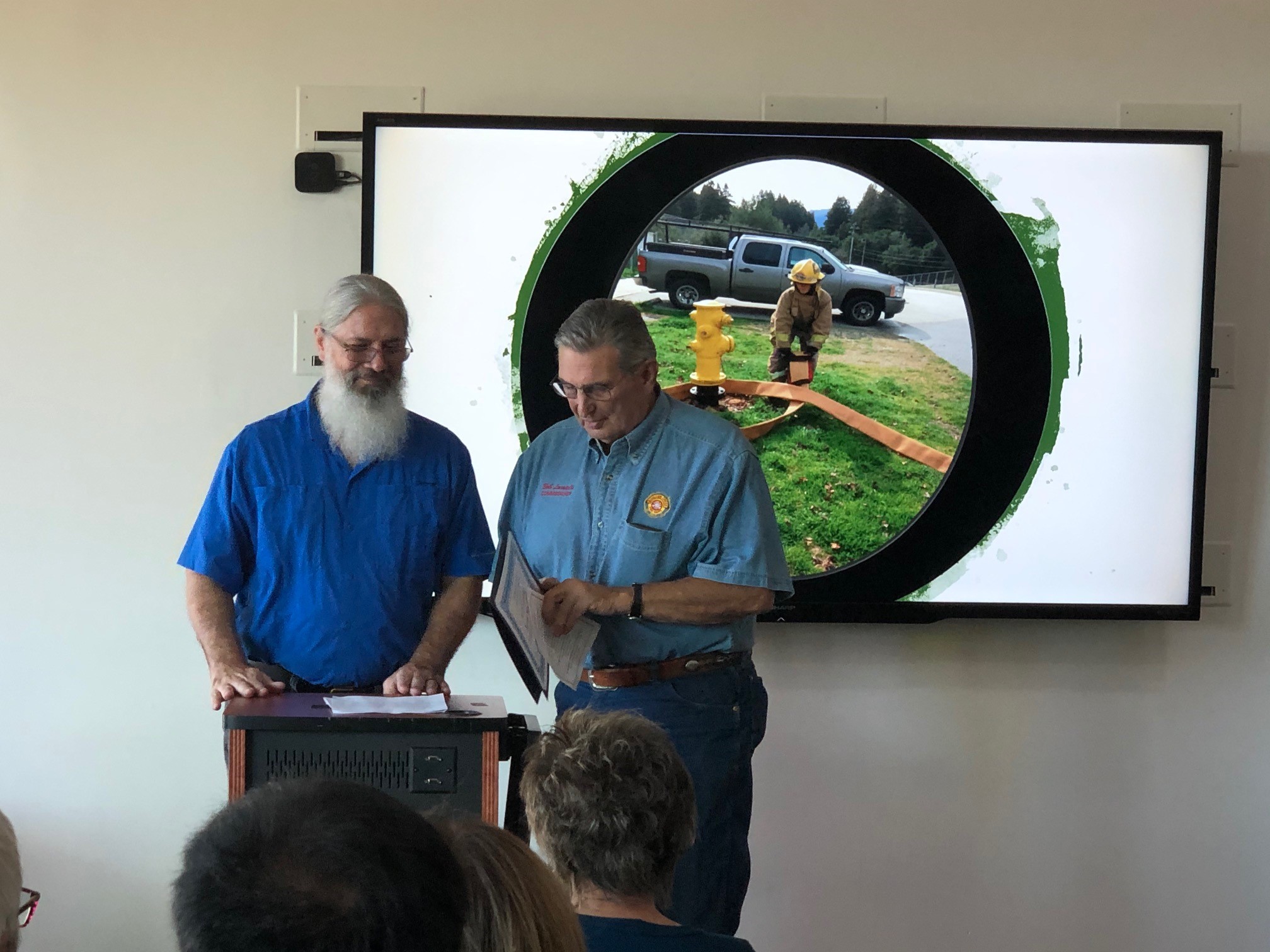 Commission Vice Chair, David Molina, presents a Kudos Award to Bob Locatelli, accepting the award on behalf of Former Fire Chief, Kevin McClish