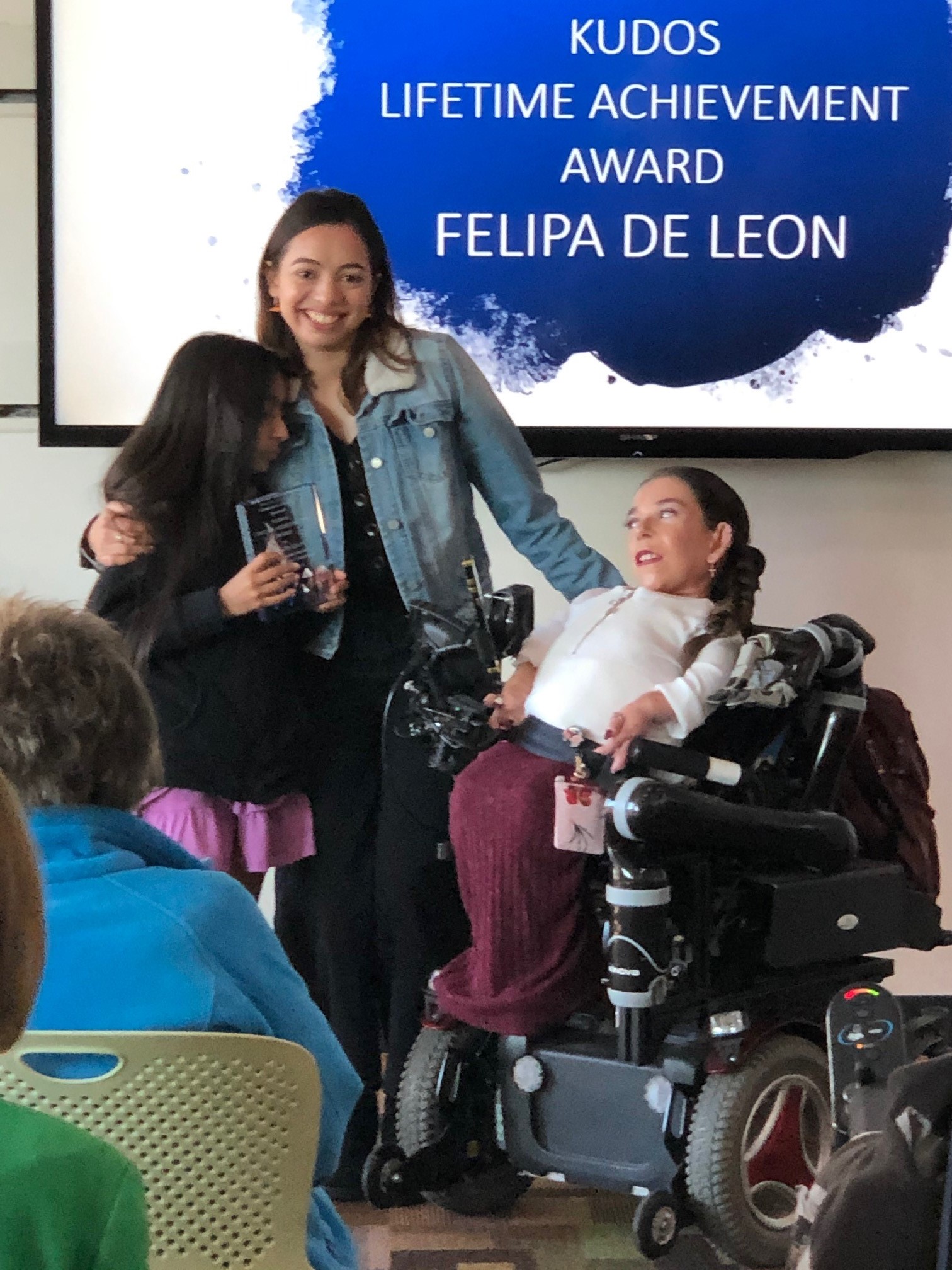 Commissioner Brenda Gutierrez Baeza presents a Kudos Lifetime Achievement Award to Former Commissioner Felipa De Leon, accepted by her family.